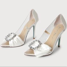 You'll Be Sending Out All The Luxe Vibes When You're Wearing The Betsey Johnson Sb-Moxie Ivory Satin Rhinestone Pointed-Toe Pumps! Clear Vinyl Shapes A Pointed-Toe Upper And A Classic Pump Silhouette, Trimmed With Sleek Woven Satin. A Decorative Bow And Sparkling Rhinestone Buckle Accent The Vamp For A Chic Finish! The Blue Soles Add The Cutest Something Blue To Your Wedding! 4.25" Wrapped Stiletto Heel. Cushioned Insole Rubber Sole Has Nonskid Markings Satin/Lucite Slip On Entry Pointed Toe Shoe Width - Medium Rhinestone Brooch Brand New Never Worn, Changed My Mind Last Minute About My Wedding Shoes And Wore Flats. No Box Or Tags. Perfect Bridal Shoes For An Elegant Bride Rhinestone Wedding Shoes For Bridal Shower, Glamorous White Shoe Clips For Wedding, White Glamorous Wedding Shoe Clips, Glamorous White Wedding Shoe Clips, White Rhinestone Shoe Clips, Elegant White Shoe Clips With Rhinestones, Elegant White Rhinestone Shoe Clips, White Crystal Embellished Shoe Clips For Evening, White Crystal Embellished Shoe Clips For Formal Occasions