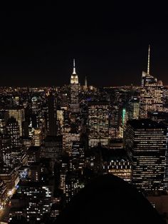 the city lights shine brightly at night in this view from top of the empire building