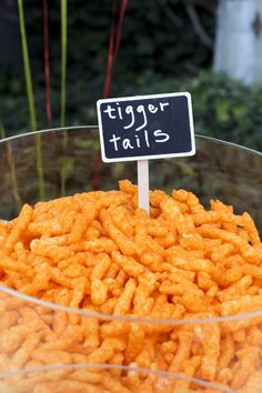 a bowl filled with cheetos and a sign that says tiger tails on it