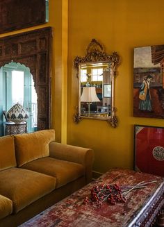 a living room with yellow walls and furniture