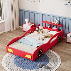 a child's bed with toy cars and toys on the floor