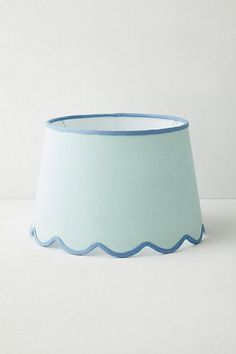 a light blue lamp shade with scalloped edges