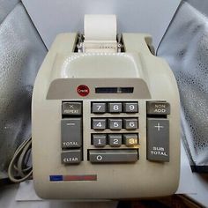 an old style cash register sitting on top of a counter