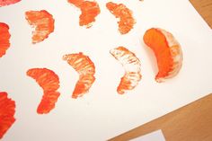 an orange peel is cut in half on a piece of paper