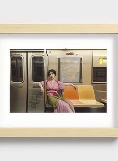 a woman sitting on a train seat with her legs crossed