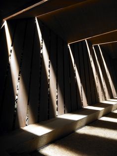 the sun is shining through some wooden beams