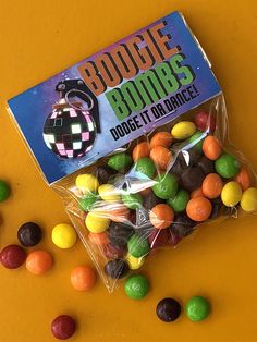 a bag filled with assorted candies on top of a yellow table