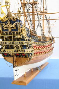 a model ship is shown on a wooden stand