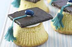 graduation cupcakes are decorated with black and yellow frosting, green tassels, and blue beads