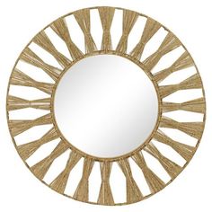 a round mirror with an intricate design on it