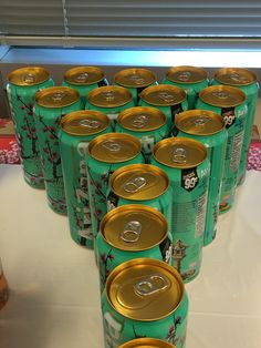 many cans of soda are lined up on a table