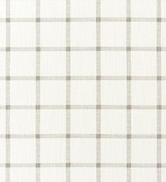 a white and grey checkered fabric with a ruler in front of the plaid pattern