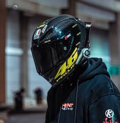 a person wearing a helmet standing in front of a building