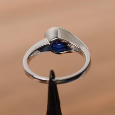 It is a lab sapphire ring. The main stone is 7mm*7mm round cut, weight about 1.63 carats.The basic metal is sterling silver and plated with rhodium.To change the metal to a solid gold (white/rose) or platinum is also available, please ask for a quotation if you want.You can also go to my shop Home for more elegant rings: https://www.etsy.com/shop/godjewelry?ref=hdr_shop_menuSapphire is the birthstone of September. More sapphire rings:https://www.etsy.com/shop/godjewelry?ref=listing-shop2-all-ite Round Sapphire Engagement Ring, Oval Sapphire Engagement Ring, White Gold Sapphire Ring, Gold Sapphire Ring, Sapphire Wedding Rings, Emerald Wedding Rings, September Birthstone Rings, Blue Gemstone Rings, Green Amethyst Ring