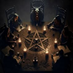 a group of people sitting around a table with candles and pentagramus on it