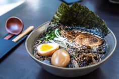 a bowl of ramen with an egg on top