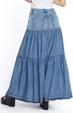 Perfect your casual-cool vibe in this denim maxi skirt designed with flouncy tiered ruffles. 37 1/2" center front length (size 29) Unlined 66% cotton, 22% REPREVE® recycled polyester, 8% polyester, 3% rayon, 1% spandex Machine wash, tumble dry Imported Flowy Denim Tiered Skirt, Flowy Tiered Denim Skirt, Summer Denim Tiered Maxi Skirt, Denim Tiered Maxi Skirt For Summer, Casual Fitted Tiered Maxi Skirt, Medium Wash Denim Tiered Skirt, Medium Wash Denim Skirt With Ruffles, Dark Wash Tiered Skirt For Spring, Medium Wash Tiered Denim Skirt