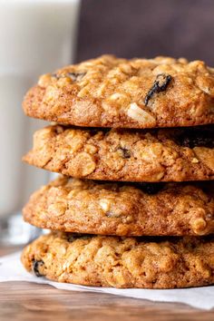 a stack of oatmeal cookies next to a glass of milk