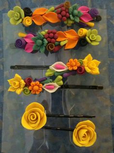 several different types of hair clips with flowers on them