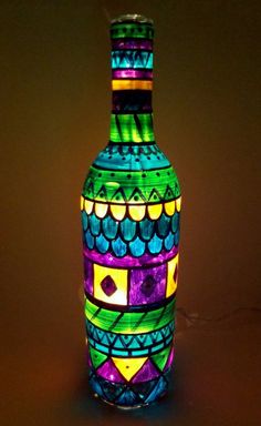 a colorful glass bottle sitting on top of a table