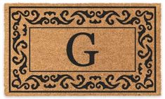 a door mat with the letter g on it and an ornamental design in black ink