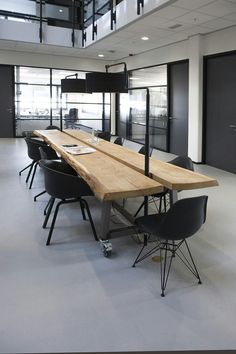 an empty conference room with chairs and a wooden table