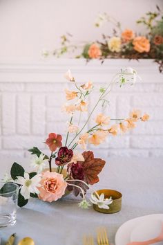 the table is set with flowers and plates