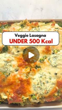 vegetable lasagna under 500 keal in a casserole dish with cheese and broccoli