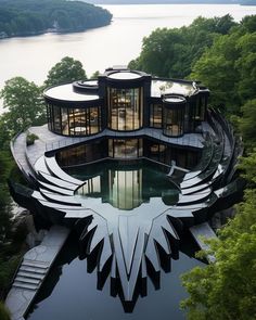 this is an aerial view of a modern house in the middle of trees and water