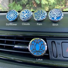 four knobs on the dashboard of a car with different colors and designs in them