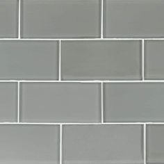 a white and gray tile wall that looks like it is made out of glass tiles