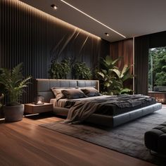 a large bed sitting in the middle of a bedroom next to a plant filled wall