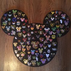 the mickey mouse ears are covered in many different disney character stickers on black paper