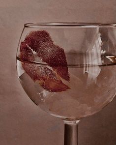 a glass filled with water sitting on top of a table