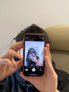 a person taking a selfie with their cell phone