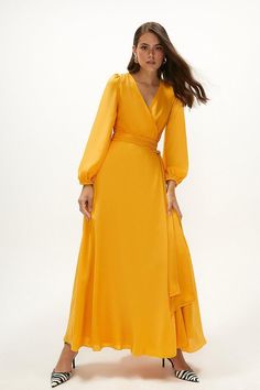 Style: Maxi DressFabric: CrepeLength: MaxiNeckline: WrapSleeve Length: Long Sleeve Orange Dress Modest, Orange Maxi Dress, Satin Maxi, Silk Maxi Dress, Satin Maxi Dress, Maxi Wrap Dress, Orange Dress, Side Split, Modest Dresses