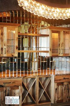 a kitchen with wooden cabinets and lights hanging from the ceiling