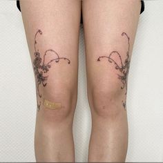 a woman's legs with tattoos on them, both showing butts and thighs