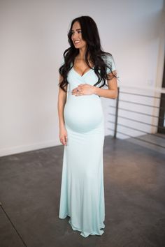 This Sexy Mama Maternity Short-Sleeve Sweetheart Maternity Gown is the perfect photoshoot or special event maternity gown! With a cross over sweetheart bust, a slim fit bodice and a simple flare this gown is equal parts comfort and elegance. The dress is perfect for any occasion! (Pictured in Robins Egg.)  Maternity gown. Maternity session. Maternity photography. Maternity dresses. Dress the bump. Best maternity. Preggo style. Maternity shoot. Maternity pictures. #SexyMamaMaternity #preggo Elegant V-neck Maternity Gown, Fitted Maxi Maternity Dress, Fitted Maxi Length Maternity Dress, Fitted Maternity Maxi Dress For Wedding, Fitted Maternity Dress With Surplice Neckline, Elegant Maternity Dress With Sweetheart Neckline, Fitted V-neck Maternity Gown, Fitted Maxi Dress For Maternity, Fitted Maternity Dress For Bridesmaids