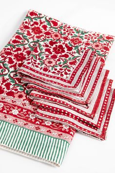 four pieces of red and green patterned fabric