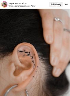 a woman with a tattoo on her ear