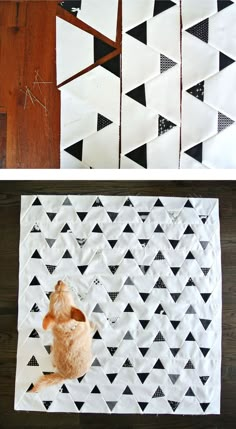 a cat sitting on top of a table next to some black and white fabric pieces