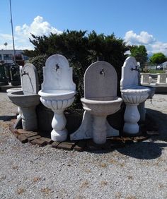 three cement toilets sitting next to each other