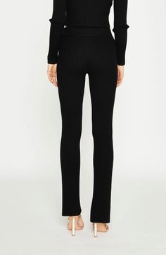 Black Knitted Flared Trousers Glamorous Women's Black Knitted Flared Trousers. Stay comfy in style with these classic rib knit flared trousers. Styled with the matching top, this knitted co-ord will be you go to whenever you want a chic and relaxed look!FEATURES Rib Knit Flared Shape Full Length Elasticated Waistband Composition: 80% Viscose 20% PolyamideModel Wears Size 10.Model Height: 5'10" Chic Ribbed Elastane Bottoms, Elegant Ribbed Stretch Bottoms, Ribbed Fitted Bottoms For Winter, Elegant Stretch Ribbed Pants, High Stretch Ribbed Elastane Pants, Fitted Ribbed Elastane Pants, Ribbed Elastane Pants, Elegant Black Ribbed Bottoms, Black Full-length Ribbed Pants