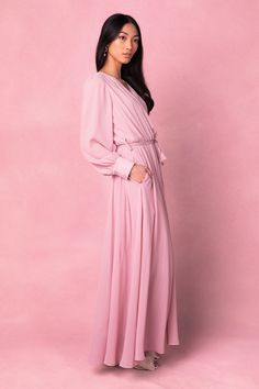 model:Hannah|X-Small Pink V-neck Gown For Spring, Elegant Pink Asymmetrical Maxi Dress, Elegant Flowy Pink Dresses, Pink V-neck Midi Dress For Wedding Guest, Pink Flowy Chic Maxi Dress, Feminine Pink Maxi Dress For Evening, Chic Pink Flowy Maxi Dress, Chic Pink Maxi Dress For Wedding Guest, Elegant Mauve V-neck Maxi Dress