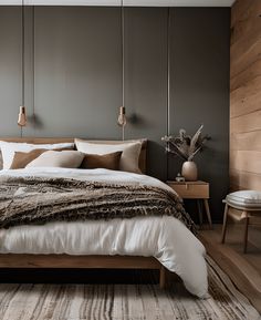 a large bed sitting in a bedroom on top of a wooden floor next to a chair