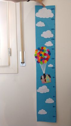 a child's growth chart with a hot air balloon in the sky on it