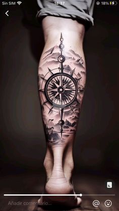 a person's leg with a compass tattoo on it