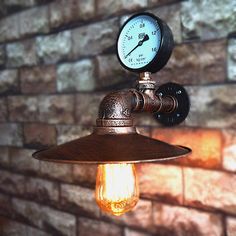 an old fashioned light bulb hanging from a brick wall