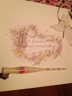 a card with an angel on it next to a pen